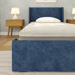 Modern bedroom with blue upholstered bed frame, textured white mattress and pillow, wooden nightstands with table lamps
