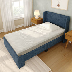 Modern bedroom with twin mattress featuring textured wavy cover on a blue upholstered bed frame, wooden nightstands with lamp, white pillow and hardwood floor