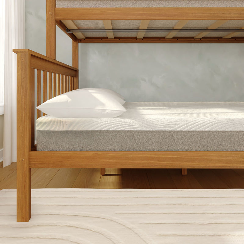 Light wood bunk bed frame with twin mattress and white pillow in a bright minimalist bedroom