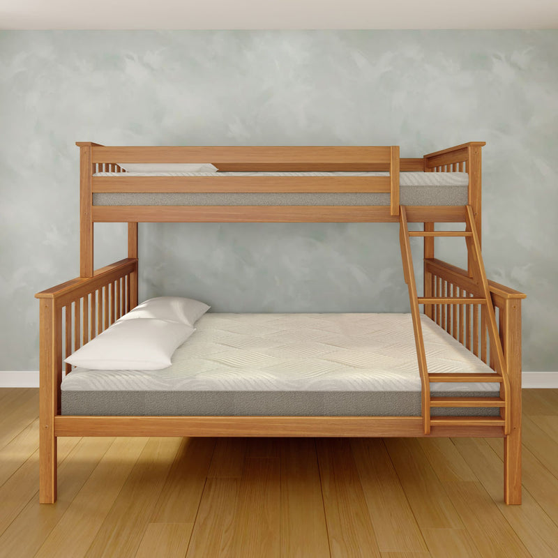 Natural wood twin-over-full bunk bed with side ladder, gray mattresses and white pillows in a minimalist bedroom with light green textured wall and hardwood floor