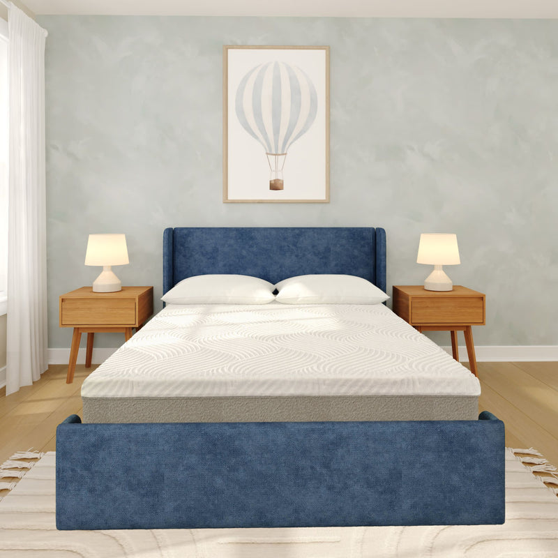 Modern minimalist bedroom with blue upholstered bed, white bedding, wooden nightstands with lamps, hot air balloon wall art and hardwood floors