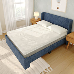 Queen-size blue upholstered bed with white textured mattress topper and pillows, wooden nightstands with lamp, hardwood floor and bright window in a modern bedroom