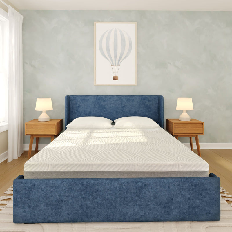 Modern minimalist bedroom with blue upholstered bed frame, white memory foam mattress, wooden nightstands with lamps, and hot air balloon wall art