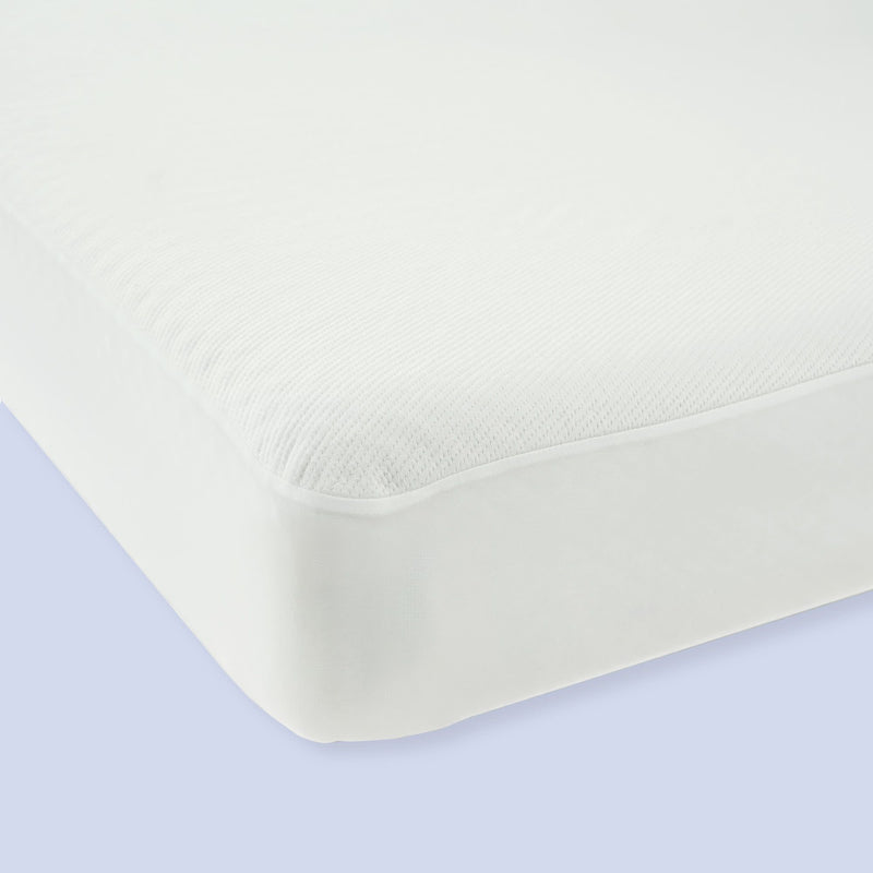 White hypoallergenic mattress protector on bed corner, providing waterproof protection and added comfort.
