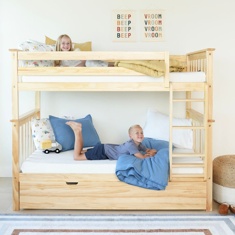 Children in a wooden bunk bed with colorful bedding in a bright, playful room.