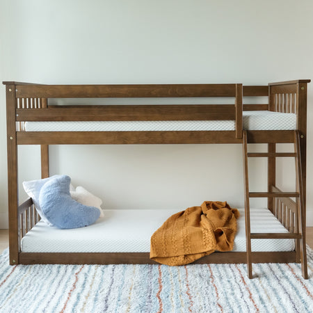Wooden bunk bed with mattress, cozy pillows, and blanket in stylish bedroom.
